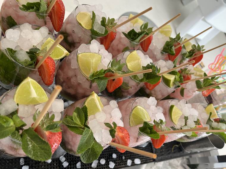 Rows of strawberry and lime mojitos on the bar